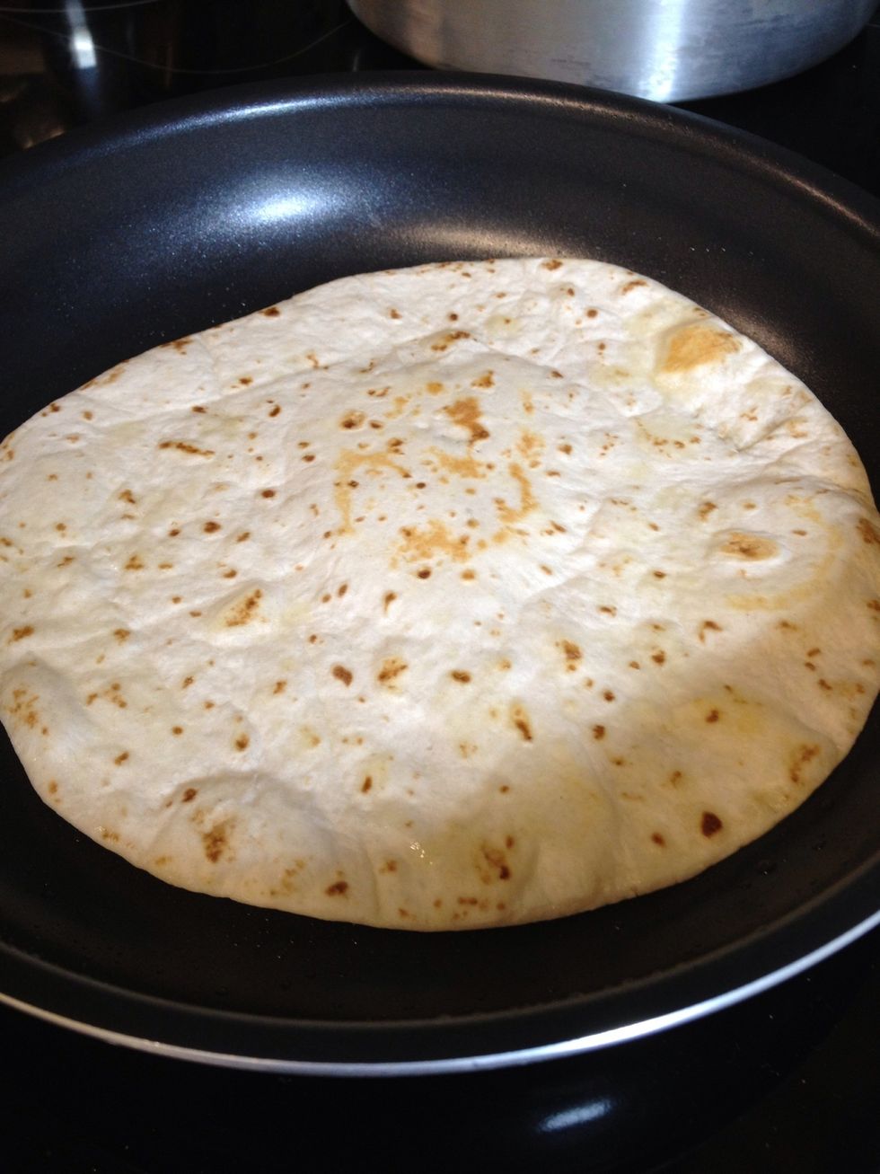 In a separate pan, brush a little bit of EVOO and warm tortillas on low heat on both sides.