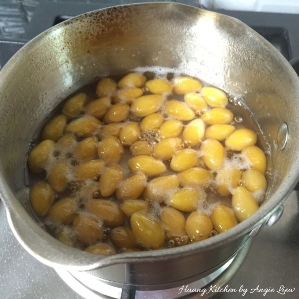 In a separate pot, slowly simmer the peeled gingko nuts in syrup for about 30 minutes or until softened.