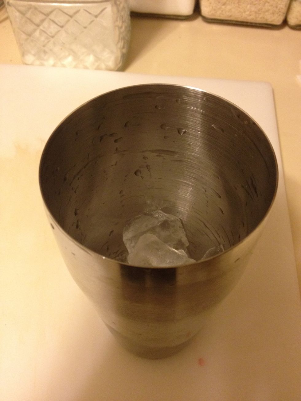 In a shaker add one scoop of ice
