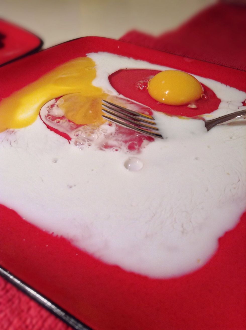 In a shallow plate beat together the 2 eggs and milk.