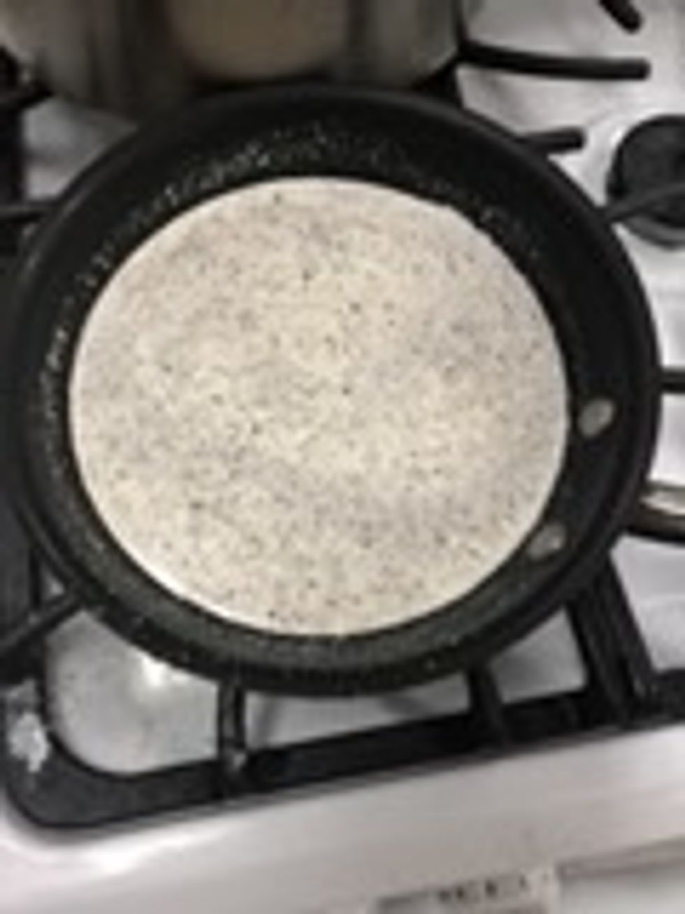 In a skillet heat chicken broth , seasonings and (the rest ) of the half and half