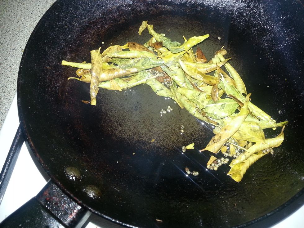 In a skillet, heat some oil. Now its time to temper some black mustard seeds. Once it pops - add the curry leaves and fry till aromatic.