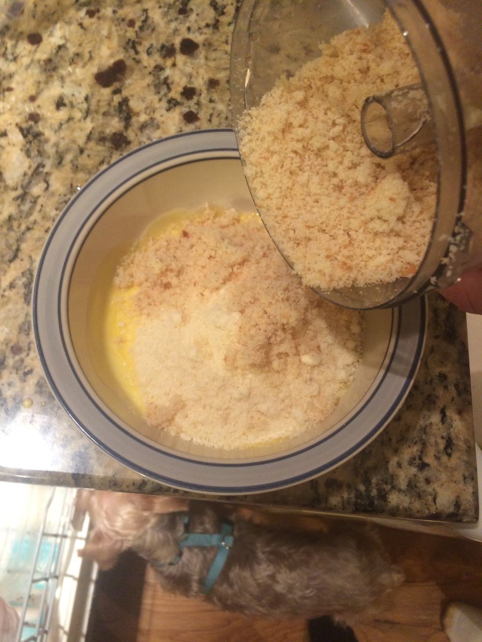 In a small bowl, stir together the Parmesan cheese, breadcrumbs and butter (melted)