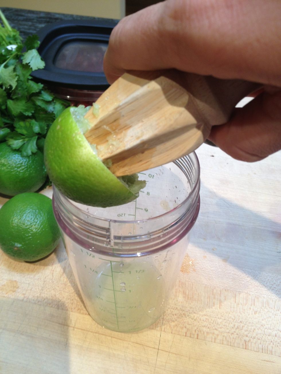 In a small lidded jar or salad shaker, juice the lime.