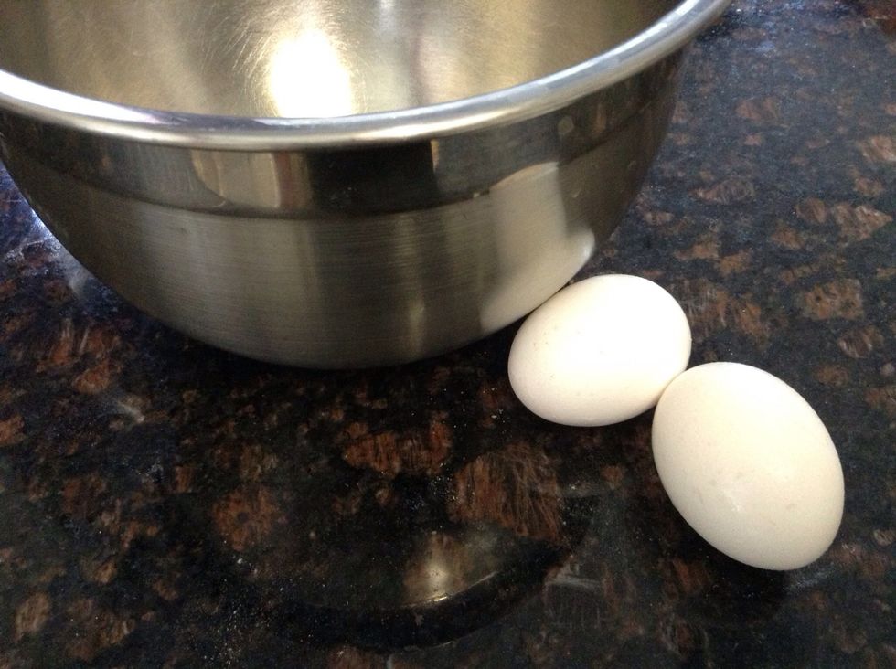 In a small mixing bowl lets gather our "wet" ingredients. Start with 2 eggs at room temperature. Whisk until well beaten.