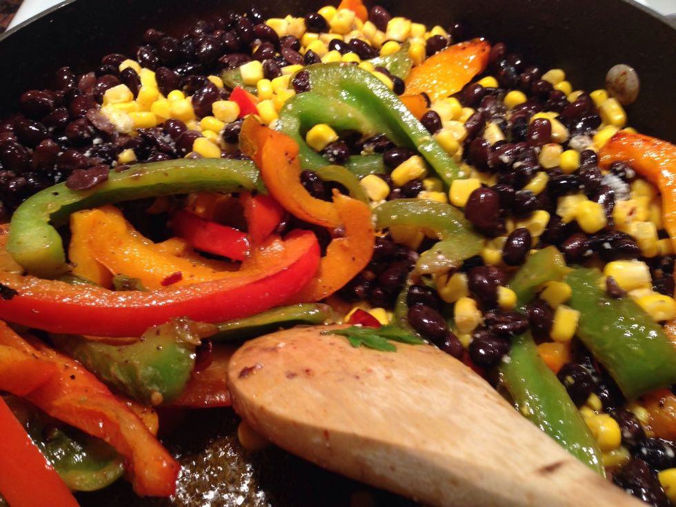 In a small mixing bowl take corn, beans, hand full of trimmed cilantro, squeeze of lemon, and a pinch of seasoned salt. Mix well, then add to bell pepper mixture.