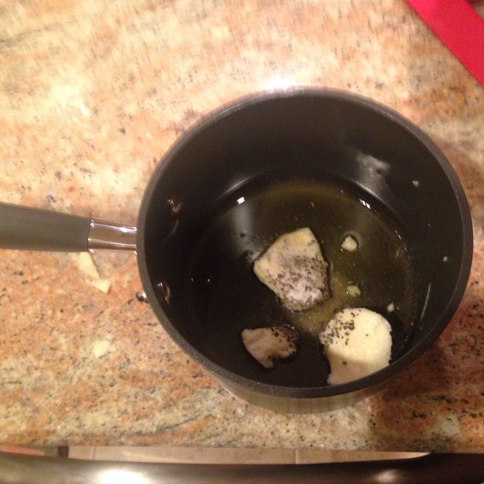 In a small sauce pan, melt the butter with the olive oil over medium heat. Stir in the basil.
