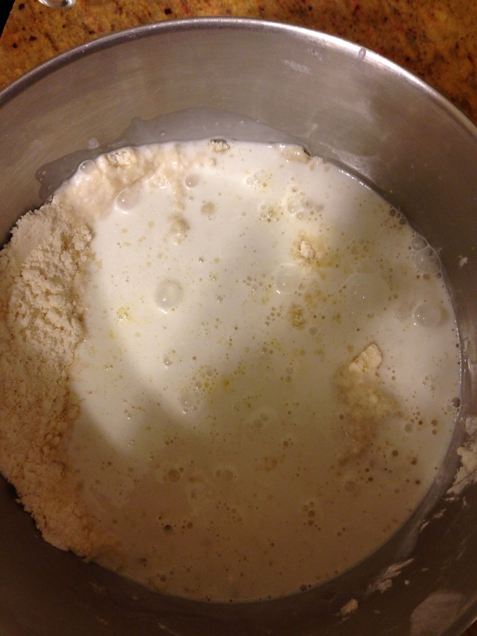 In a small saucepan warm up but don't boil coconut milk. When it is just steaming a little pour into flour mixture & add beaten egg.