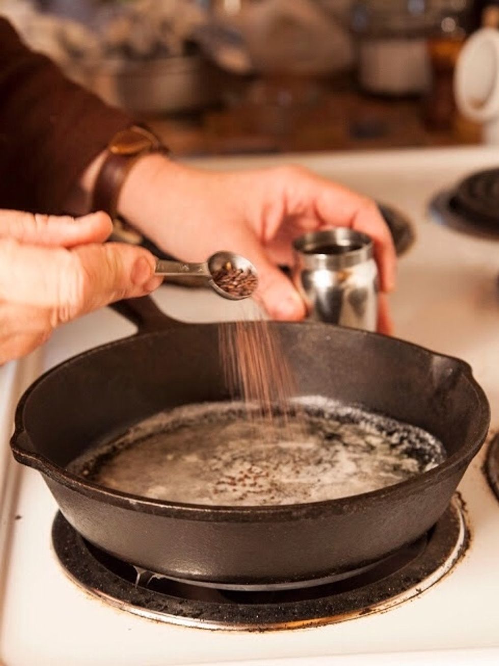 In a small skillet, heat 1/4 cup unsalted butter. When the butter is hot, toss in 1 and 1/2 Tbs of mustard seeds.
