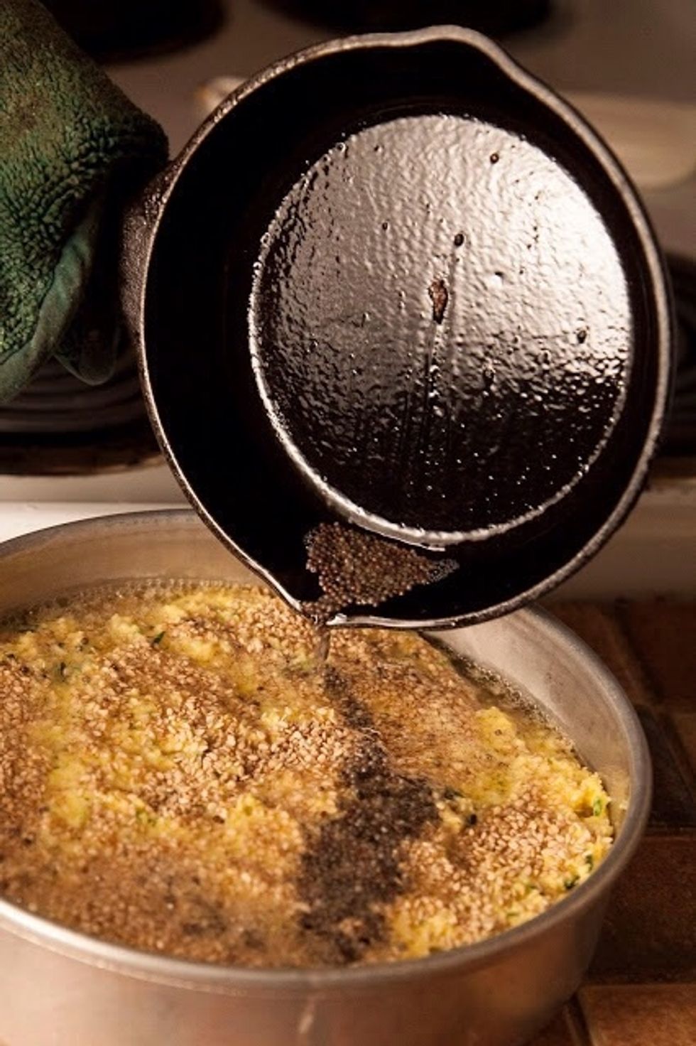 In a small skillet heat 2 Tbs of vegetable oil. When the oil is hot, toss in 1 tsp of brown mustard seeds. When they pop and sizzle pour the vegetable oil and mustard seeds over the cake batter.