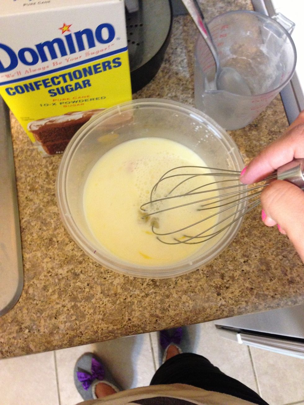 In a smaller bowl, add the milk and your two eggs. Mix this together. Don't mind my little house slippers \ud83d\ude01
