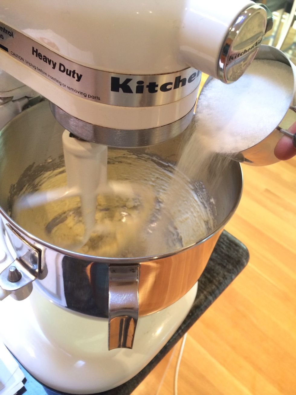 In a stand mixer, with the paddle attachment, cream the butter until soft, and then gradually add the sugar. Continue beating until light and fluffy.
