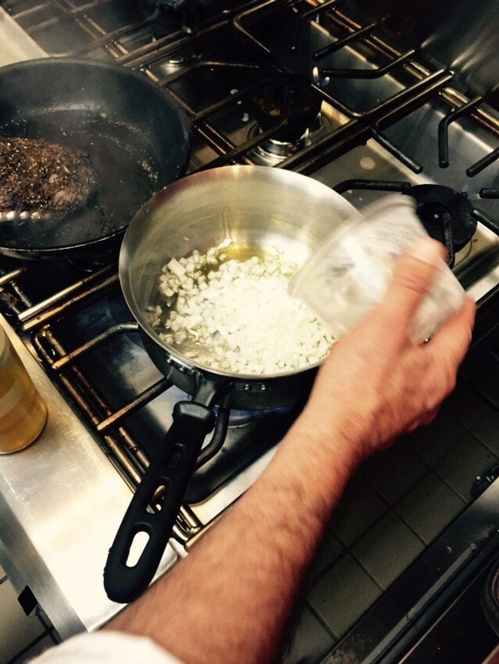 In a stovetop pan, saut\u00e9 onions in olive oil.