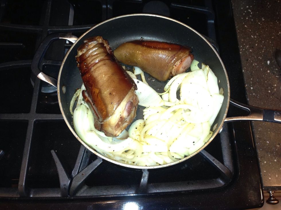 In a very hot frying pan, add the onions and ham hicks with a small amount of olive oil. The goal is to sear the ham hocks and saut\u00e9 the onions to combine the favors.