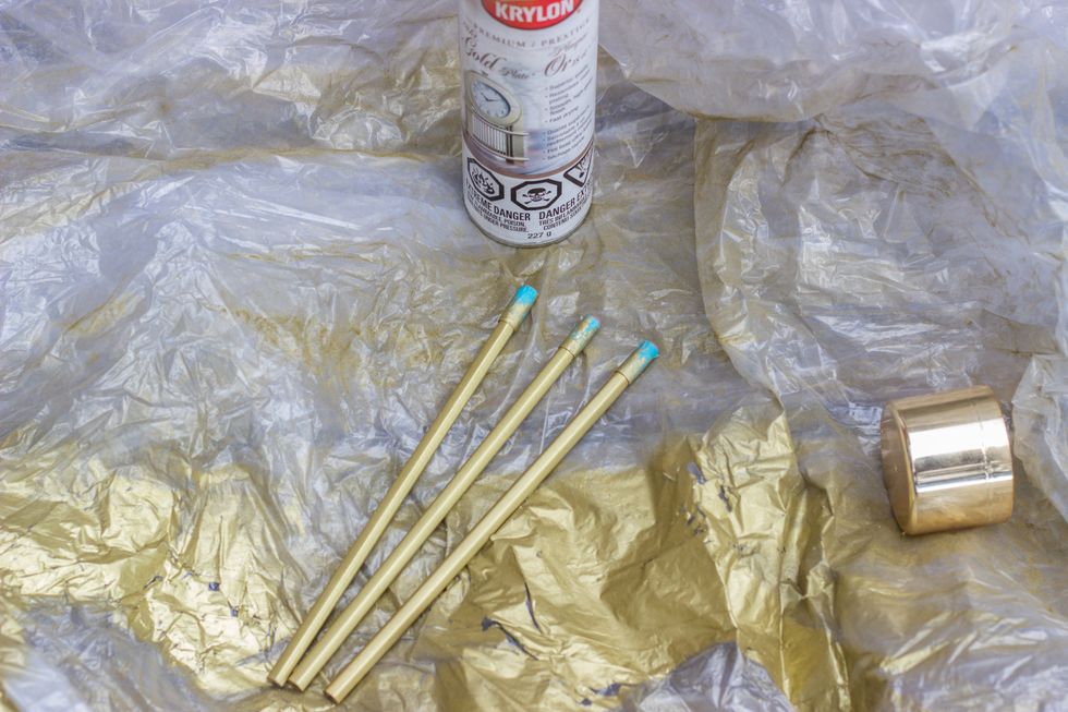 In a well ventilated area or outside, grab your spray paint and paint your pencils. Let them dry completely.