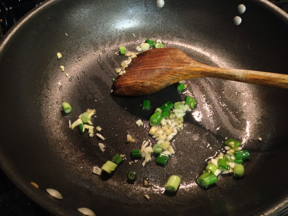 In a wok or saut\u00e9 pan, heat up canola oil and add ginger, garlic and scallion.