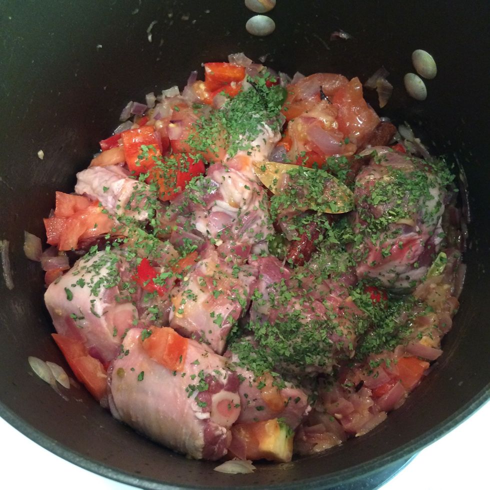 In about 3-5 minutes add tomato, lamb meat and dried cilantro. Keep stirring the ingredients in the stock pot until the mixture starts to water a bit.