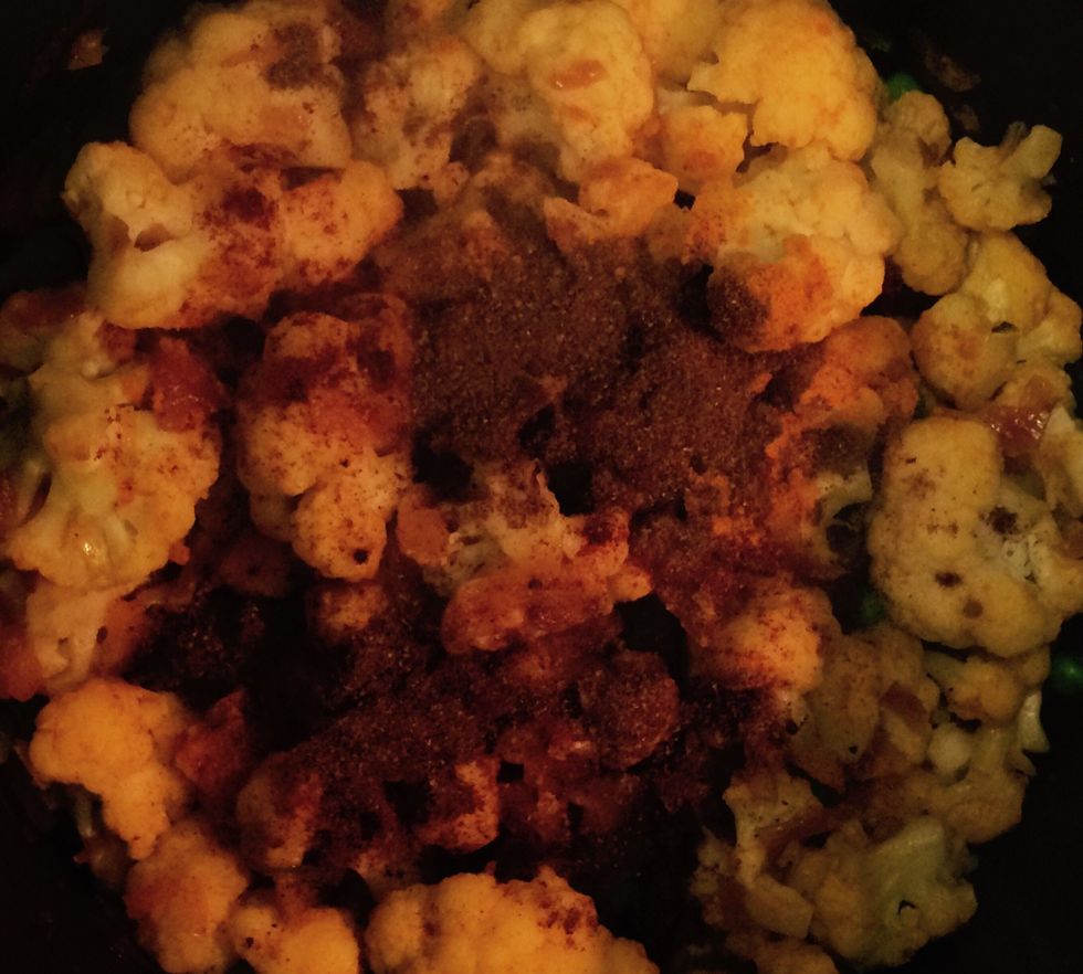 In about 5 mins. as the mixture starts to water, add 1/2 teaspoon of ground turmeric, 1/2 teaspoon of paprika and 1 teaspoon of the garam masala. Mix thoroughly.