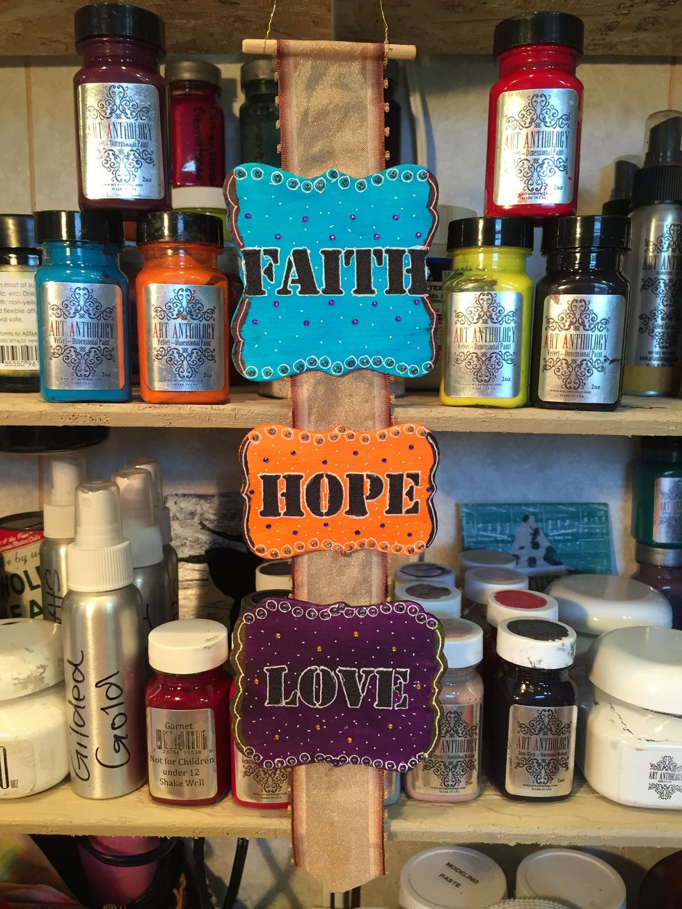 In an effort to salvage the project, I did a little doodling. Take a white Gelly Roll pen, I added circles around my beads and white dots over the entire surface of each plaque.