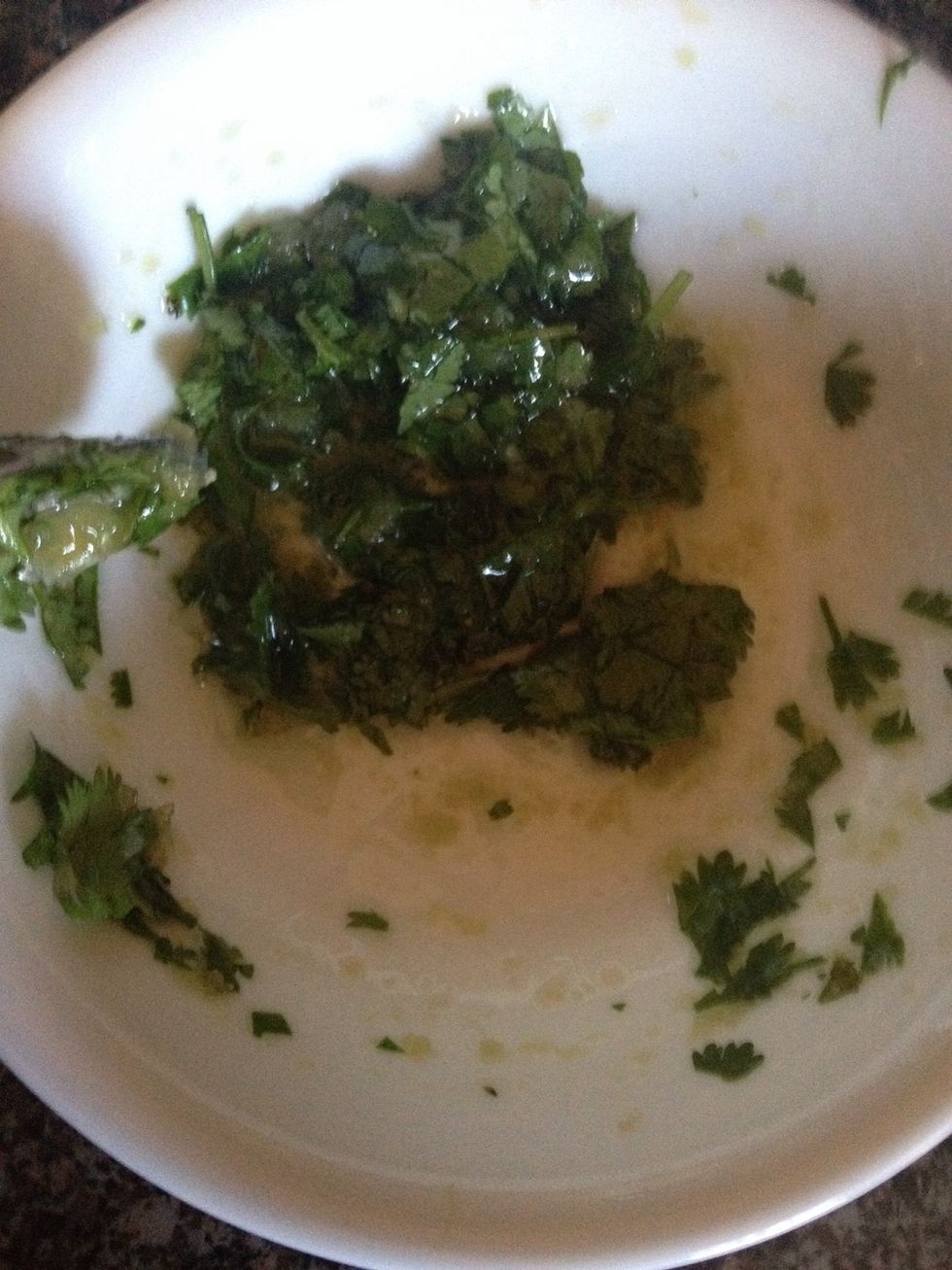 In another bowl add olive oil, crushed garlic and cilantro this is optional if your like me and like your naan tasty you can also eat them plain