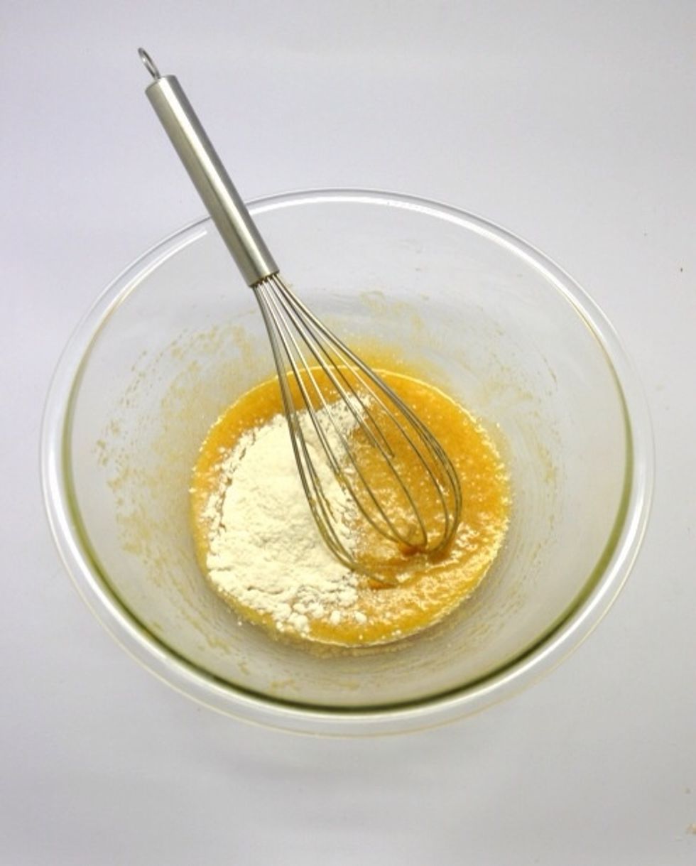 In another bowl, place the flour and baking powder and mix it to combined. Now, add 1/3 of the flour to the earlier (butter, sugar, egg and vanilla) mixture.