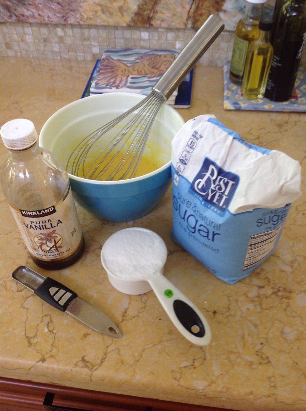 In another bowl, whisk the egg yolks until thick and pale in color. Whisk in the remaining 1/2 cup of sugar and the vanilla.