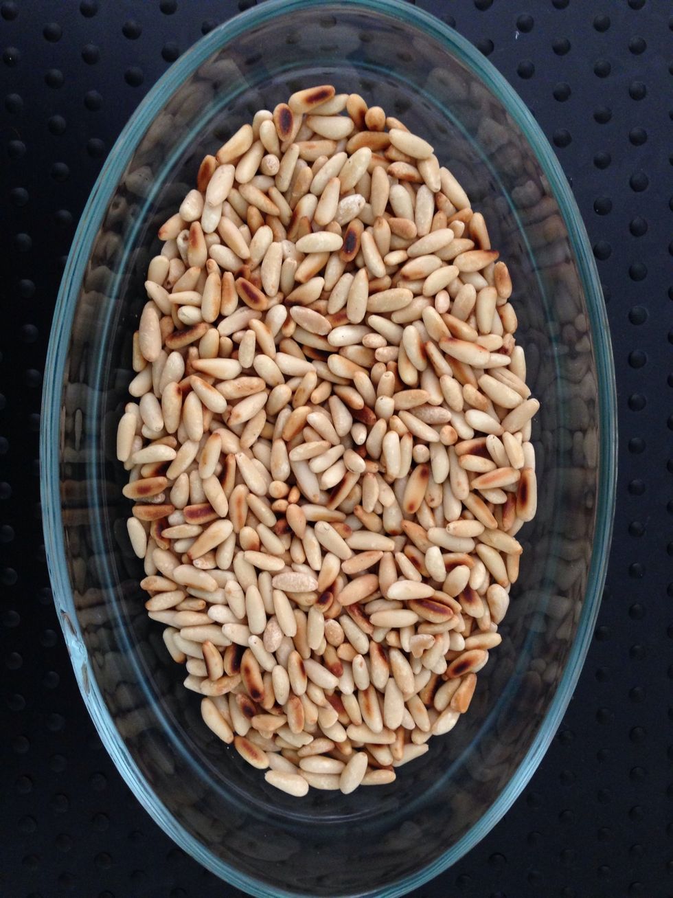 In another frying pan and without any fat, Start to Grill 100 g of pine seeds they will b done by the time  meat is done