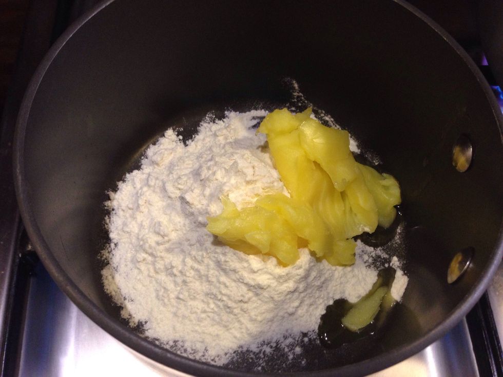 In another pan put the flour and ghee together over the heat