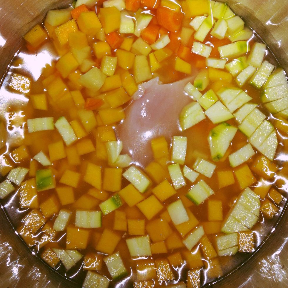 In another pot, place vegetables (washed, pealed and cut small), chicken breast and chicken broth or water. Heat until boiling, then cover the pot and reduce the heat to cook them slowly.