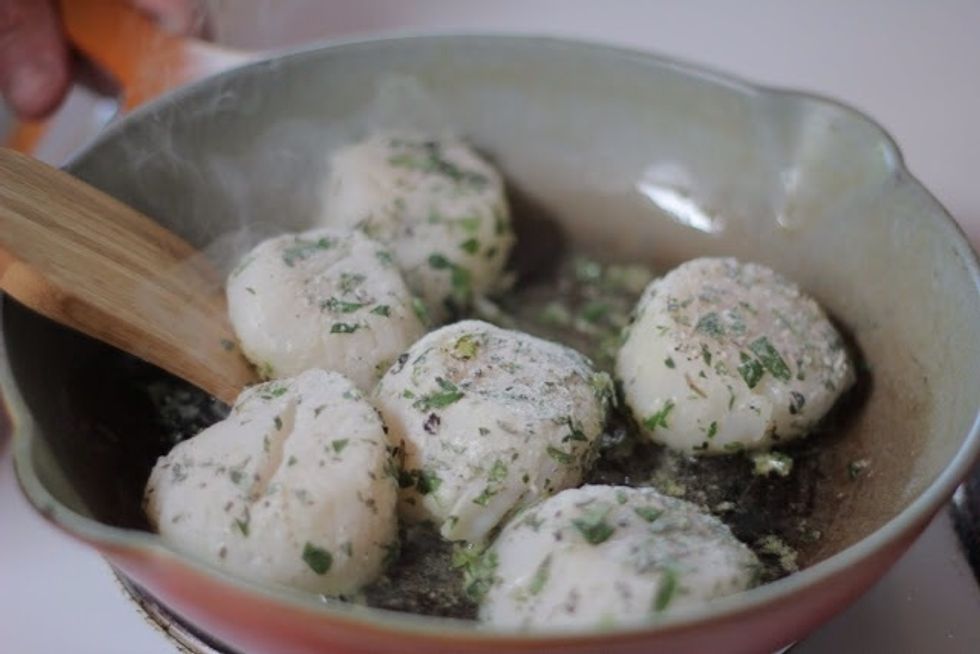 In another skillet heat 2 Tbs of olive oil  When the oil is hot quickly sear the scallops in the pan. Turn them only once. When they're firm and golden they're done.