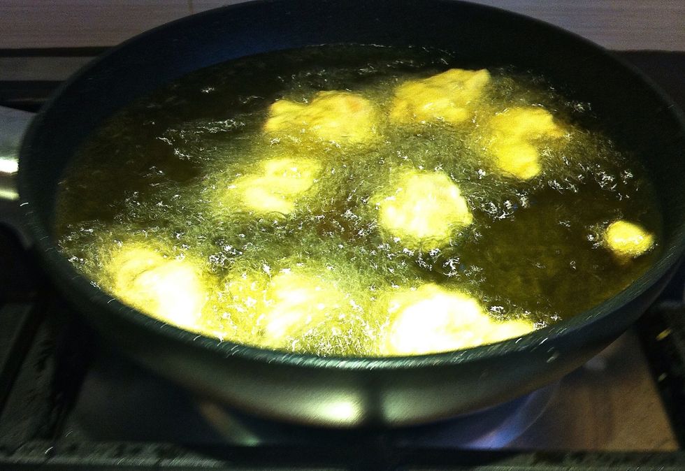In batches, drop the chicken cubes one at a time in the oil. Deep fry until they turn golden brown and begin to float, about 3 minutes.