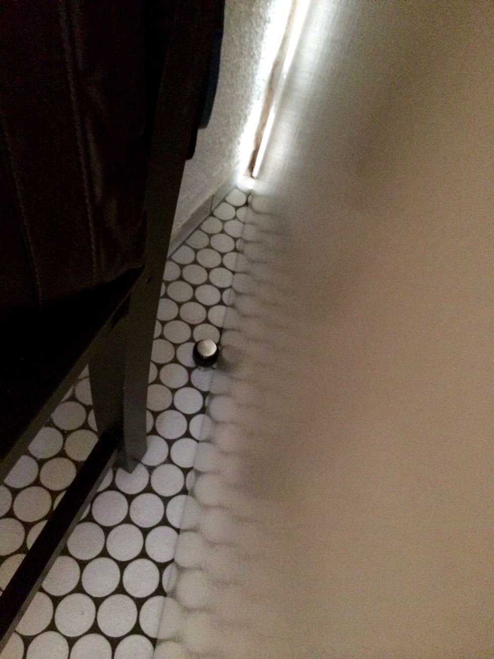 In case you have a door that might crash into your modern piece of art-like coat rack, install a door stopper.