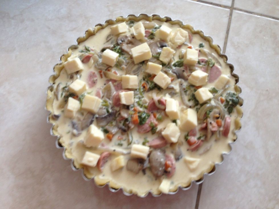 In clean bowl, whisk 4 eggs and milk. Add half teaspoon of salt & pepper. Stir in 1 cup of cheese.add saut\u00e9ed sausage & veggie to the bowl. Then pour filling to the crust and bake at 325 F for 45 min.