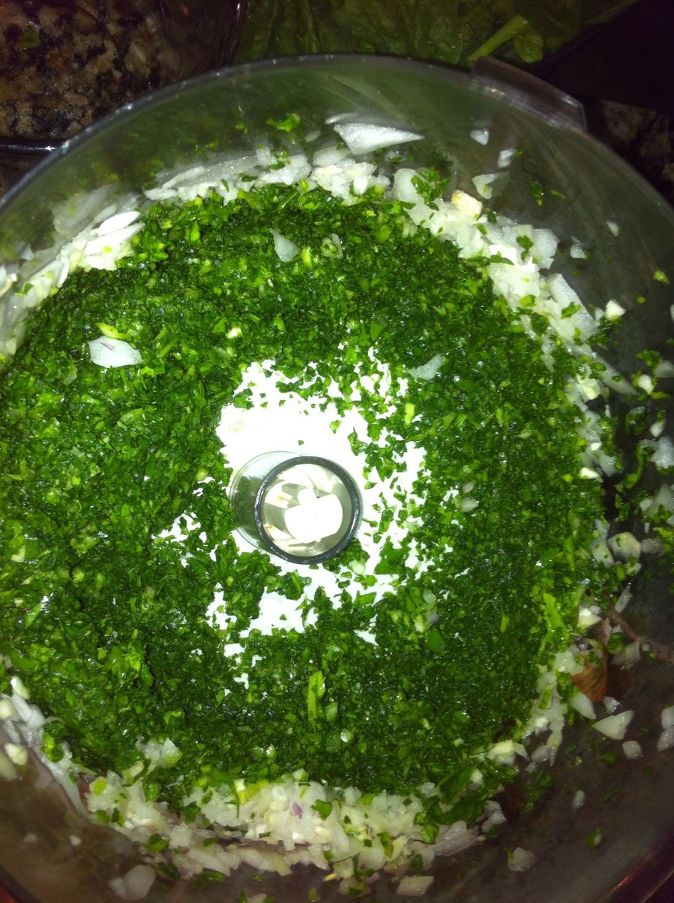 In food processor, first blend onion and garlic then add spinach.