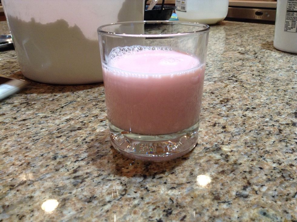 In four tall serving glasses each, first add chilled milk along with 1-2 tbsp of rose syrup. Stir until fully mixed.