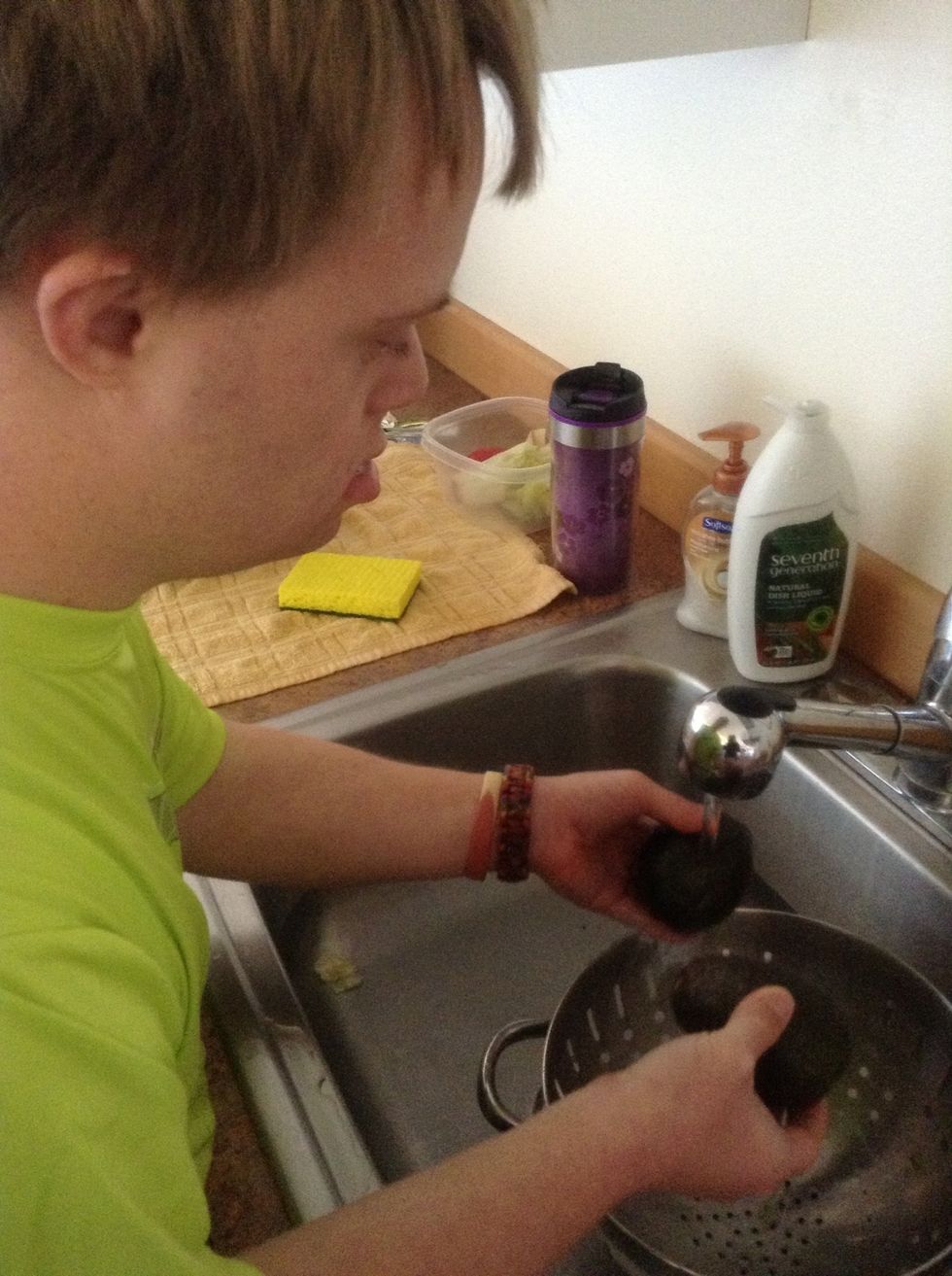 In kitchen sink wash avocados.