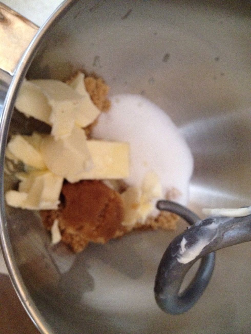 In large bowl beat butter and sugar (brown and white). Using Electrical mixer mix the ingredients on medium speed
