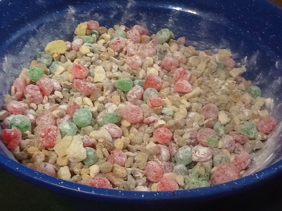 In large bowl combine almonds,red cherries,green,citron peel.raisens,candied pineapple 1cup flour