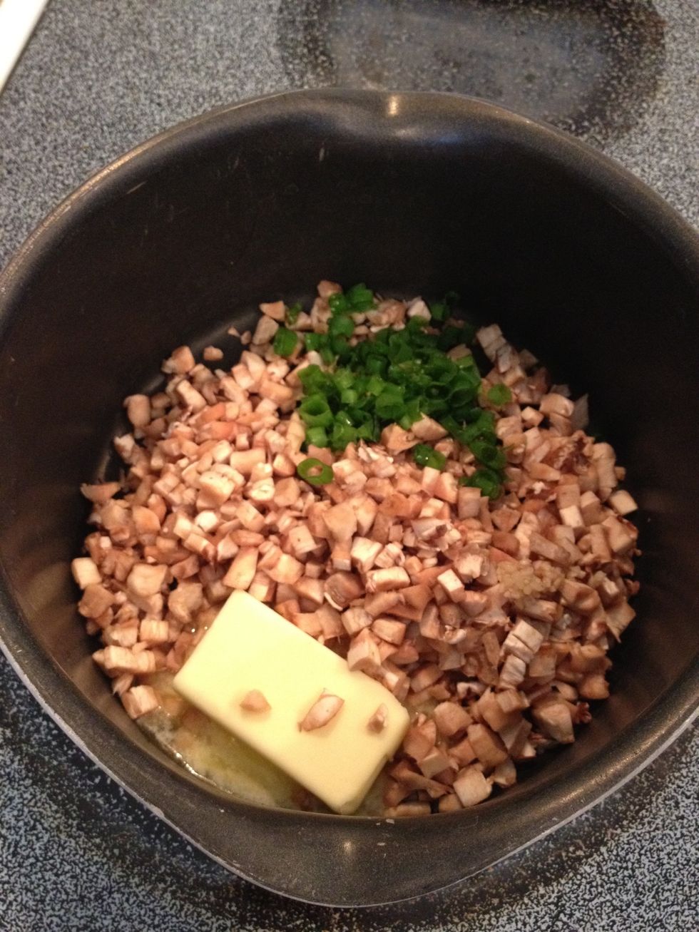 In medium saucepan, add butter, chopped mushrooms, green onions, and garlic.  When butter melts, stir well.