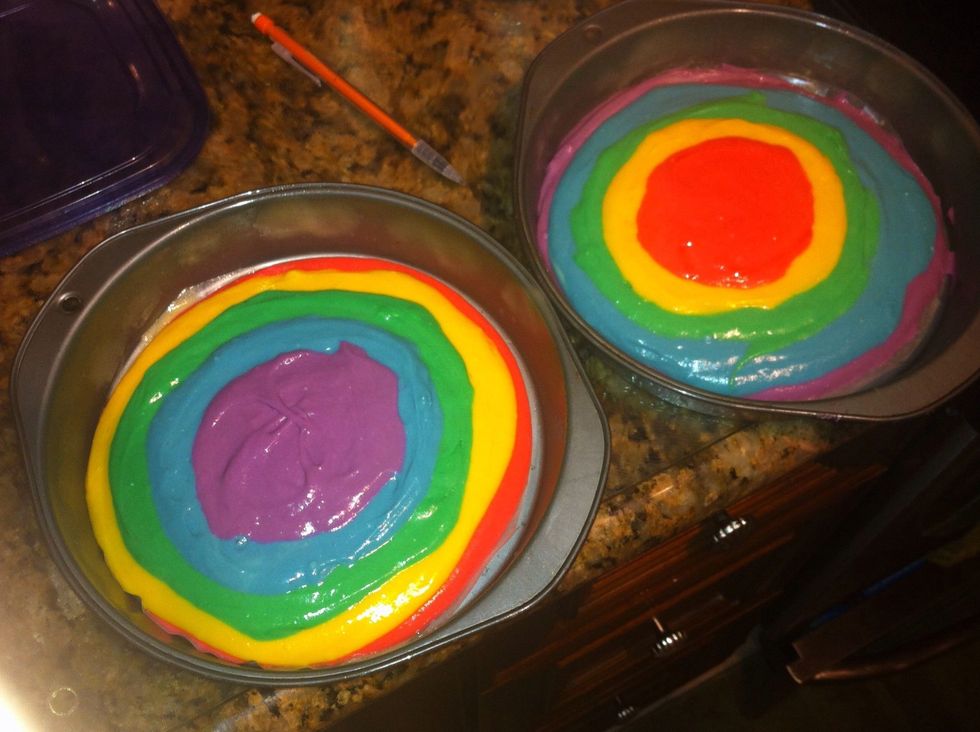 In one pan pour each color into a 9 inch round pan. Beginning with the outside in, gradually pour less. In the second pan do the same steps but reverse the colors.