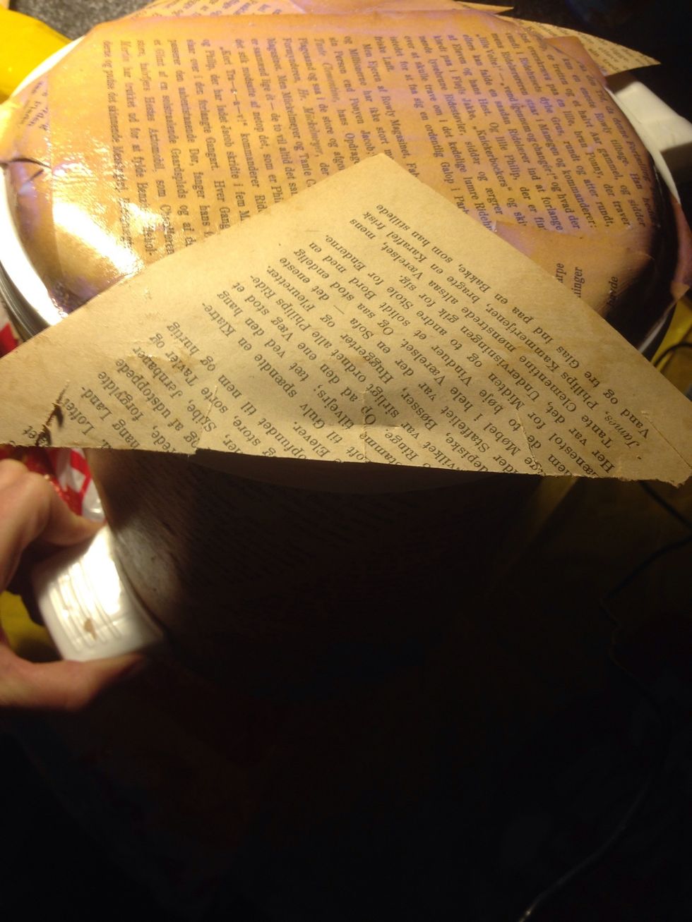 ...in order to fit it to the round edge. When you are done trim the excess paper. Don't mind how it looks, the twine will cover the edges