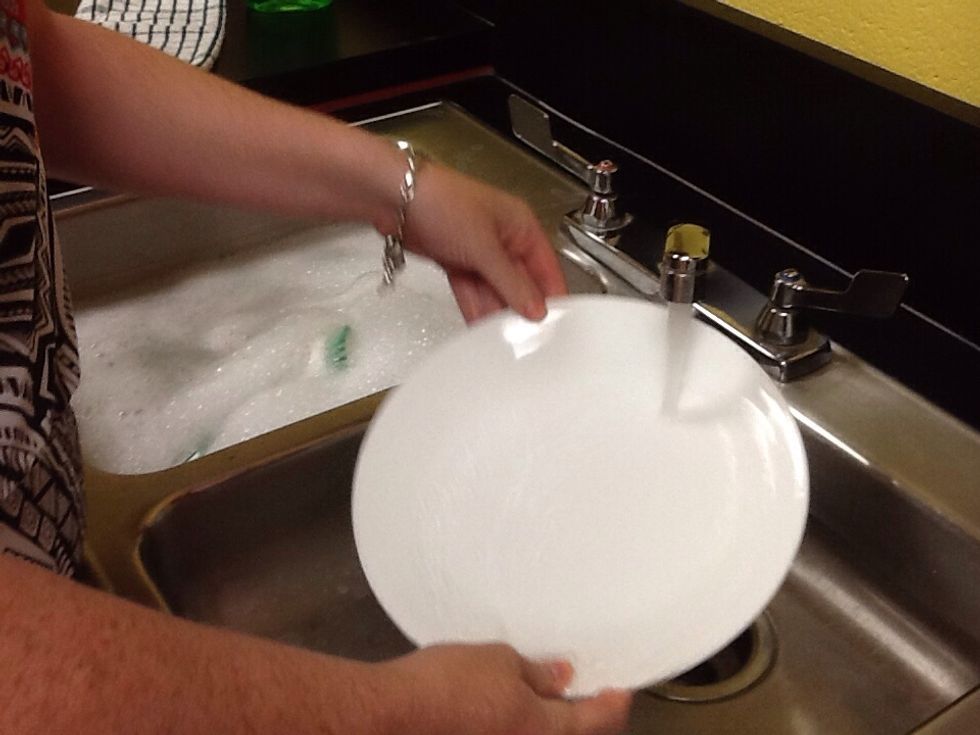 In other sink, rinse dishes in warm water. Remove bubbles from front and back. Turn water on and off, only while rinsing.
