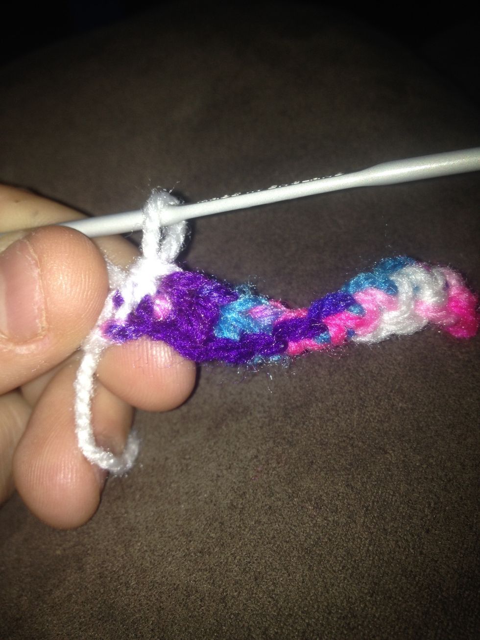 In remaining last chain make 3 half double crochet and hold in your short tail and arty it through stitches