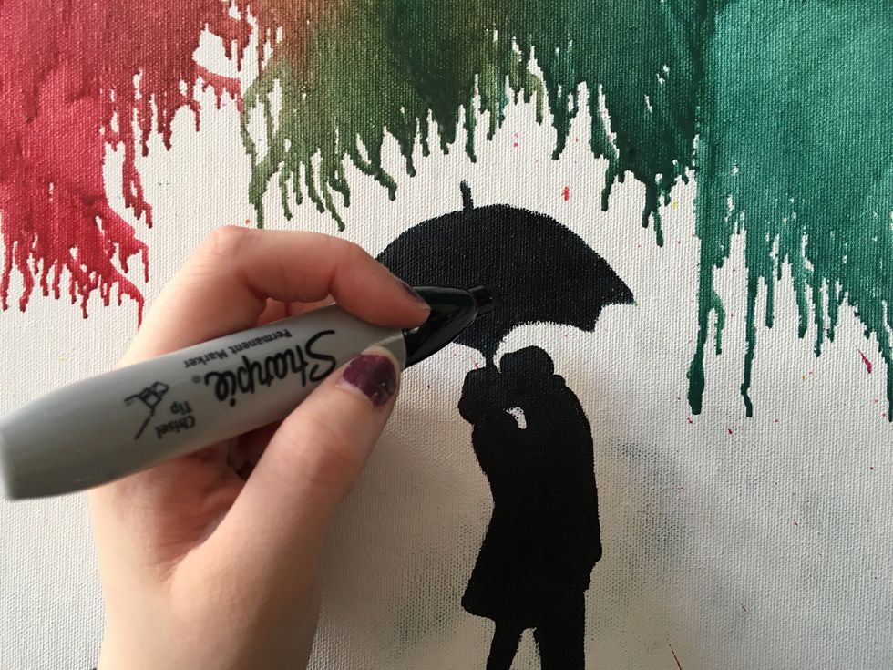 In the area that is not covered in melted crayon you may draw an illustration using a black sharpie to create a more unique and personal art piece.