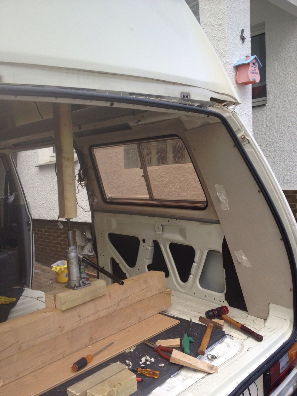 In the back you will need to use significant force to convince the roof to let go of the car. I used a car-jack.