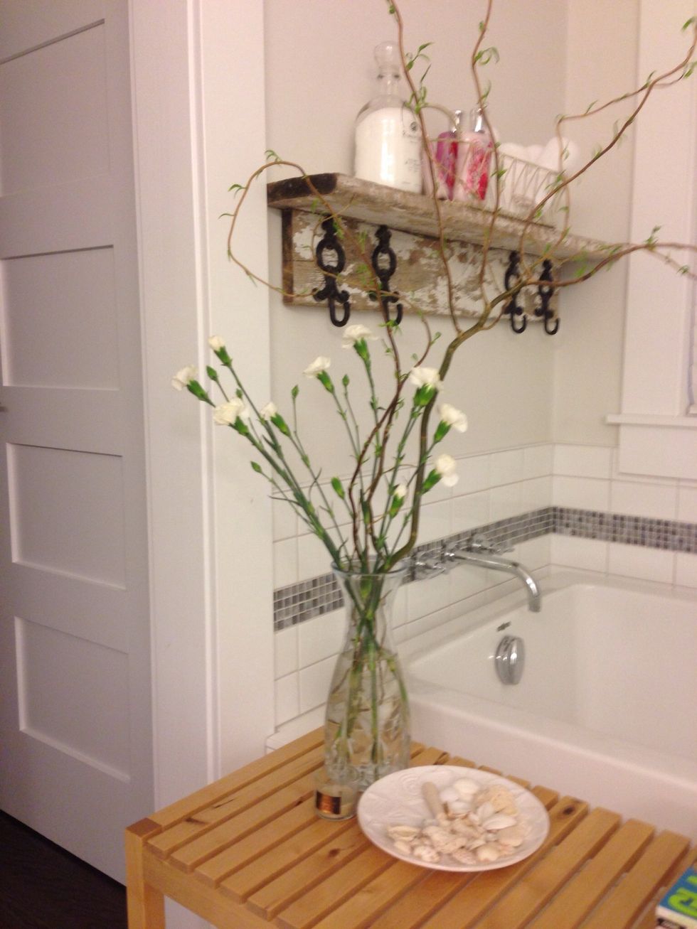 In the bathroom, some Willow branches and flowers in a more glamorous vase. Seashells, not only makes for a nice serenity touch, but also a nice conversation starter, especially if from your trip!