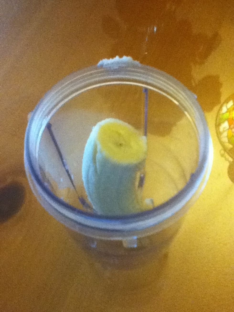 In the blender, put half of the banana.