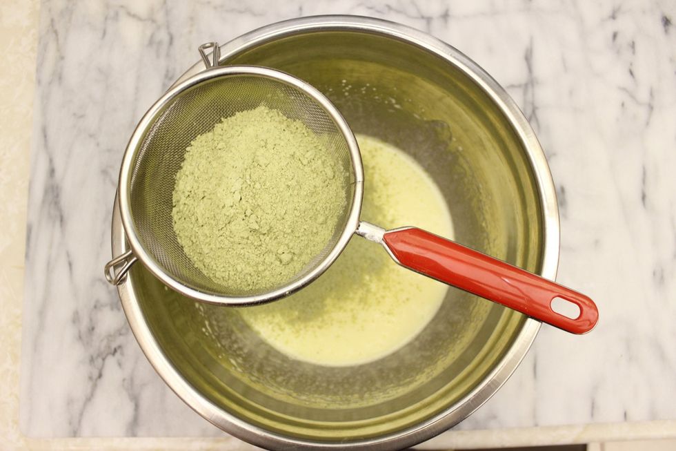 In the bowl of your egg yolk mixture, sift in the matcha-cake flour.