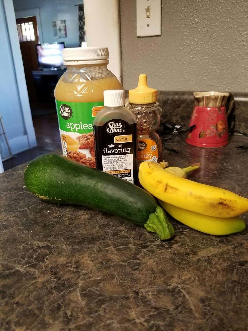 In the bowl of your mixer, add the apple sauce, honey, eggs, vanilla, zucchini, and mashed bananas. Mix on medium low until it's all mixed well.