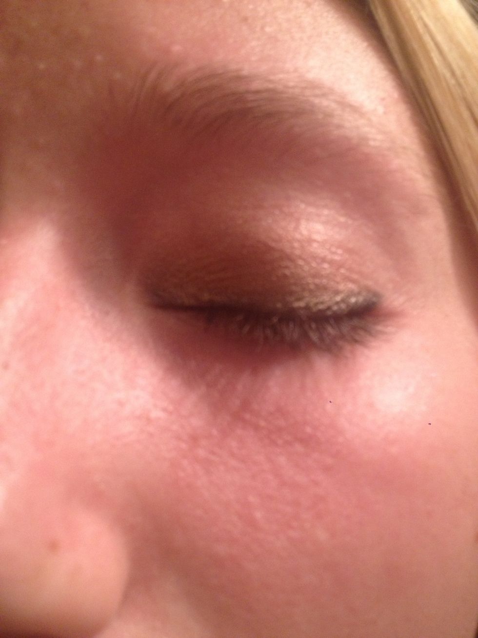 In the crease and a little above the lid